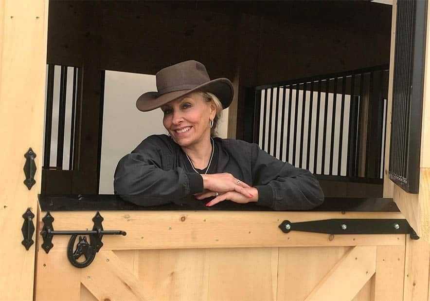 woman in horse barn